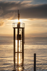 Arbon 0162-2024, Leuchtturm im morgendlichen Gegenlicht