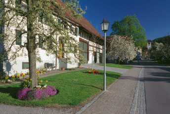Bankholzen, Bauernhof und Dorfkirche im Frühling